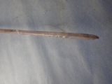 a small wooden stick that is laying on the ground