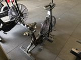 a bike and a fan in a gym room