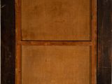 an old wooden frame with a brown and black design on it