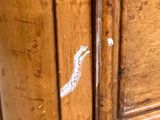 a close up of a wooden cabinet with a white bird on it