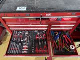 a red tool box with tools in it on a table