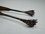 pair of antique silverware spoons on a white surface