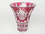 a glass vase that is sitting on a white surface