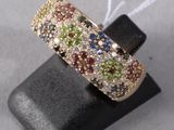a close up of a gold ring with multi colored stones
