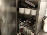 a stainless steel cabinet filled with pots and pans