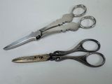 two pairs of scissors sitting on a white surface