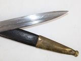two knives that are laying side by side on a table