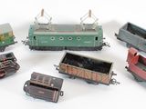 several toy trains are lined up in a row on a white surface
