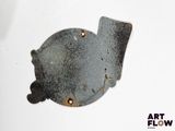 a metal object that is sitting on a white surface