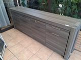 a large wooden cabinet with drawers on the floor