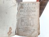 an old book with writing on it sitting on a table