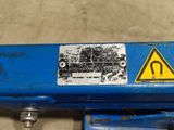 a close up of a blue machine with a warning sign on it