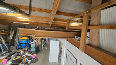 a picture of a garage with a lot of stuff on the floor