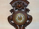 a clock on the wall with a green apple on top of it