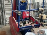 a picture of a red and blue truck with buckets of paint