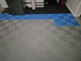 a blue and grey floor with a black and white checkered pattern