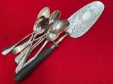 a lot of spoons and spoon spoons on a red table