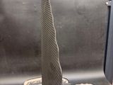 a sculpture of a cone on a table next to a laptop