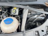 the engine of a car with the hood open and the oil tank open