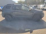 a grey suv parked in a parking lot with other vehicles