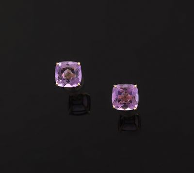 a pair of amethorate earrings on a black background