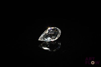 a close up of a diamond on a black surface