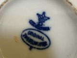 a close up of a blue and white cup and saucer