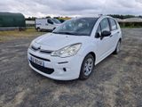 une petite voiture blanche garée dans un parking