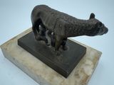 statue of a cat on a marble base on a white background