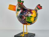 a colorful painted bird on a black stand