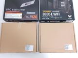 two boxes of computer equipment sitting on top of a white surface