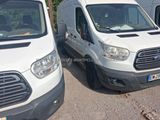 two white vans parked next to each other in a parking lot