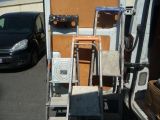 an image of a van with a ladder and a chair in the back