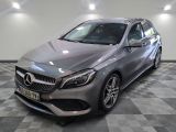 the mercedes cla is parked in a garage with a checkered floor