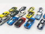 a lot of toy cars that are on a white surface