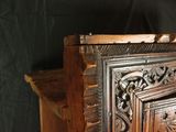 a wooden cabinet that has a carved design on it