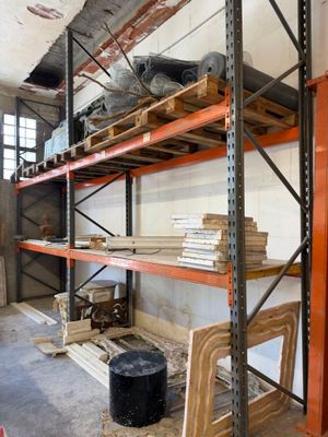 a room that has a lot of shelves and a chair in it