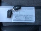 a car key sitting on top of a piece of paper in the back seat of a car