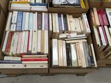 boxes of books are stacked on top of each other in a room