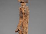 a wooden sculpture of a person holding a piece of wood