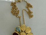 gold plated flower necklace with multi colored stones and a price tag