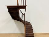 an image of a wooden staircase with a wooden handrail