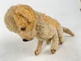 a small stuffed animal that is standing on a white surface