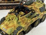 a model of a military vehicle on display in front of a box