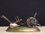 a bronze sculpture of a horse pulling a cart