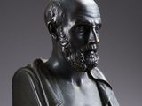 a bronze bust of a man with a beard and mustache