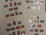 two sheets of paper with stamps on them sitting on a table