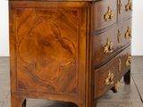 an antique chest of drawers on a wooden floor in a room
