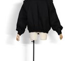 the back of a mannequin wearing a black jacket on a mannequin stand