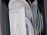 a lot of plates in a black box on the floor